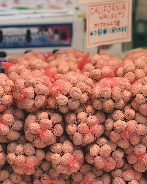 California walnuts in red mesh bags piled up